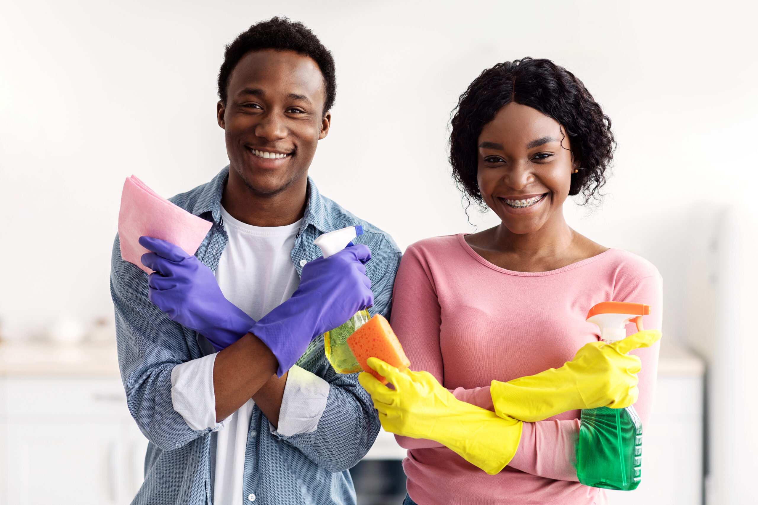 Beautiful black couple posing with cleaning tools